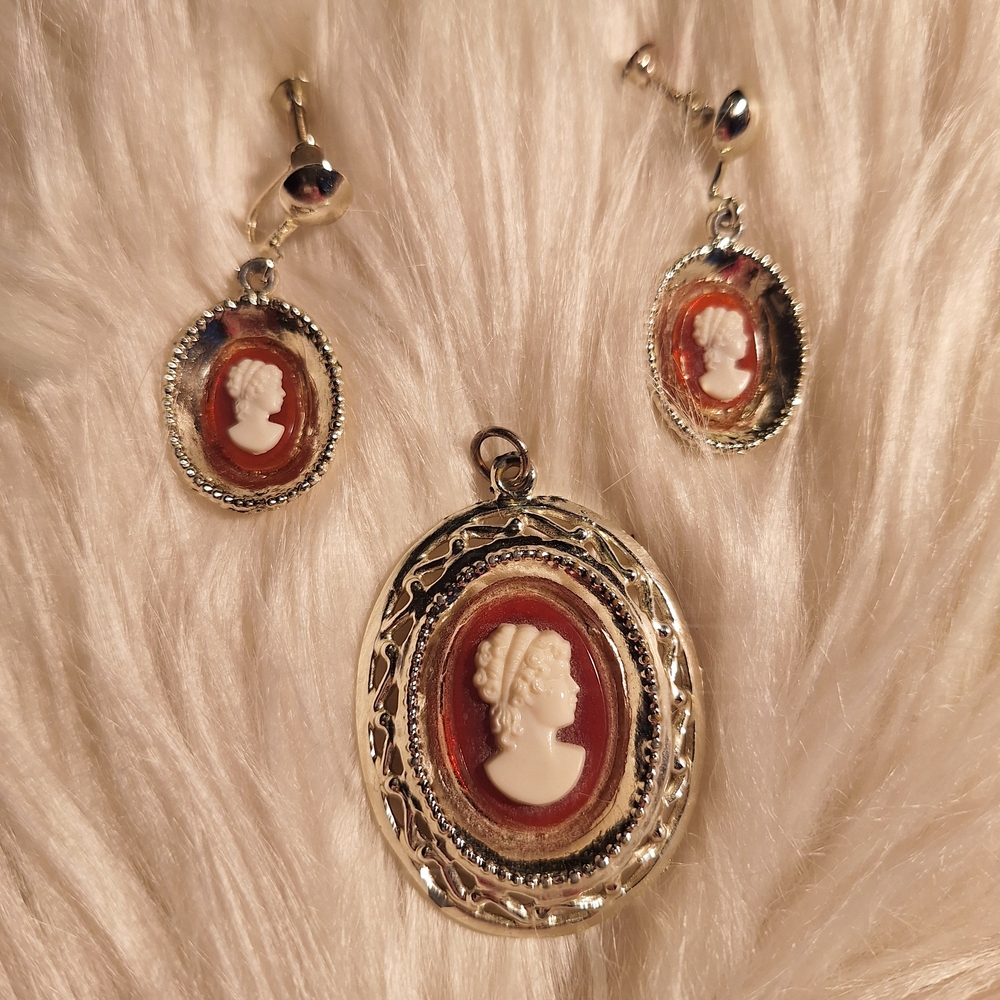 Elegant Cameo Jewelry Set in Silver and Reddish Orange.